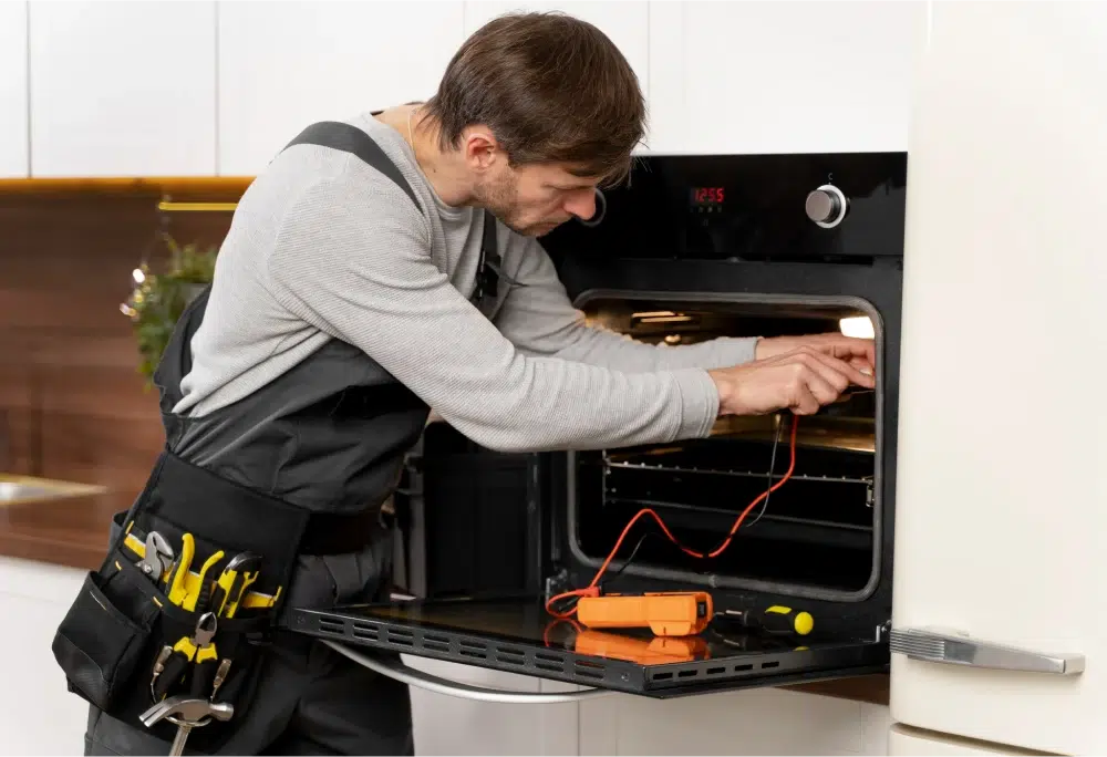 Technician repairing oven