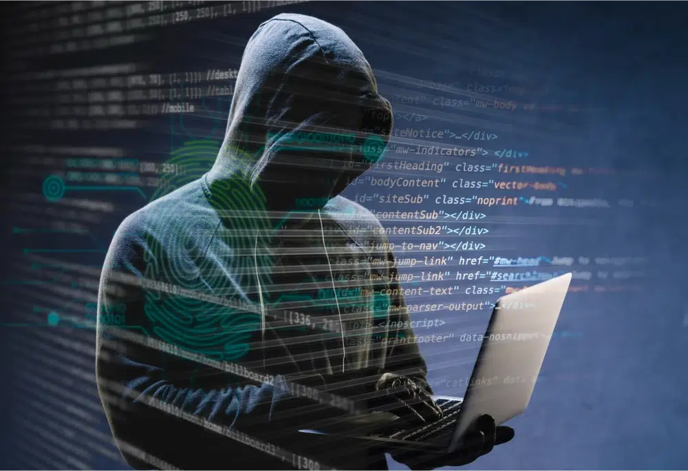 Hacker in hoodie with laptop